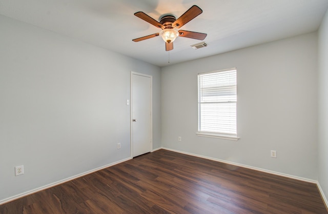 unfurnished room with ceiling fan and dark wood-type flooring