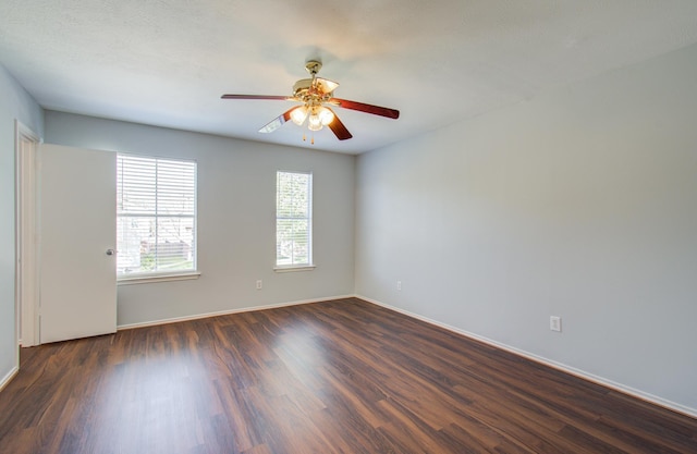 spare room with ceiling fan and dark hardwood / wood-style flooring