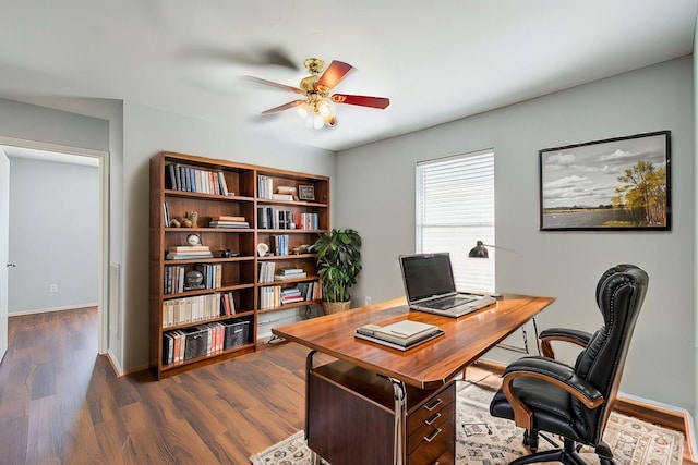 office space featuring ceiling fan and dark hardwood / wood-style flooring