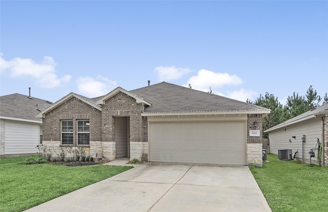 view of front of property with a front yard, a garage, and central air condition unit