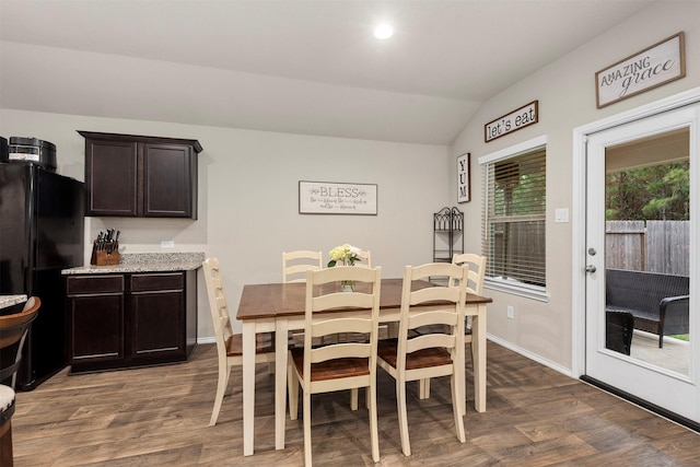 dining room with lofted ceiling and dark hardwood / wood-style floors