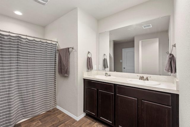 bathroom with vanity and hardwood / wood-style flooring