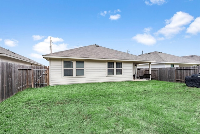 rear view of property with a lawn and a patio area