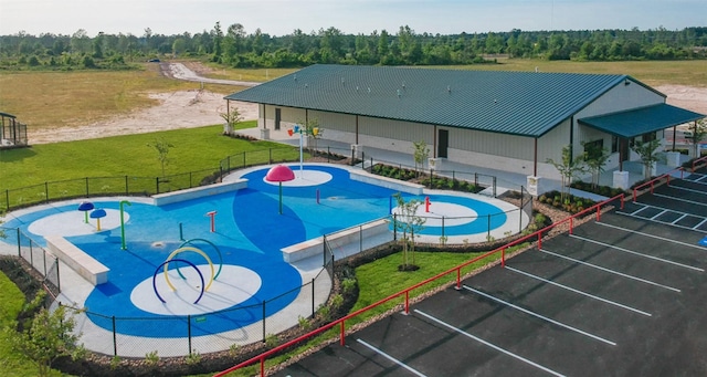 view of swimming pool featuring a yard and a patio