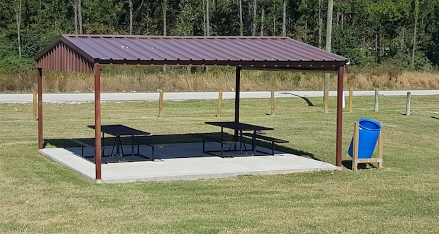 view of property's community with a yard and a patio area