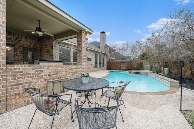 view of swimming pool featuring ceiling fan, a patio, and an in ground hot tub