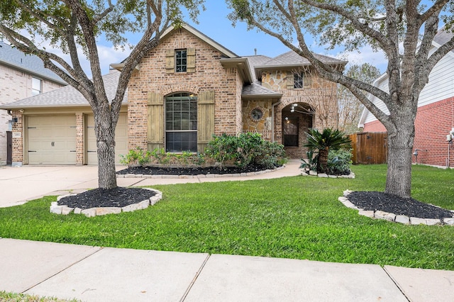 view of front of home featuring a garage and a front lawn