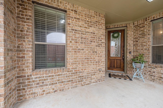 property entrance featuring brick siding