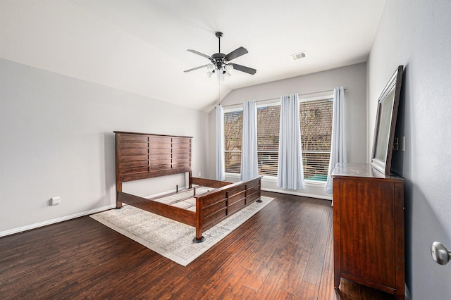 unfurnished bedroom featuring ceiling fan, dark wood-style flooring, visible vents, baseboards, and vaulted ceiling