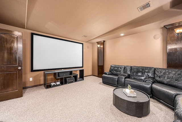 cinema featuring light carpet, baseboards, visible vents, and vaulted ceiling