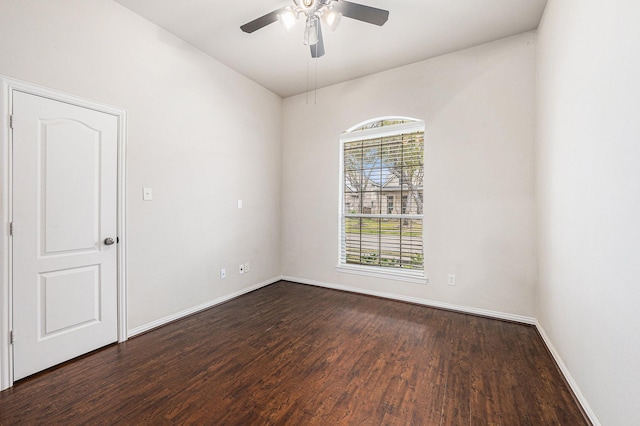 unfurnished room with a ceiling fan, dark wood finished floors, and baseboards