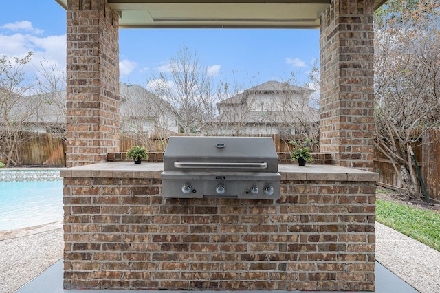 view of patio featuring a pool, fence, grilling area, and area for grilling