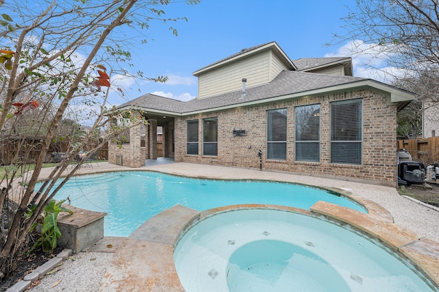 view of swimming pool with a pool with connected hot tub