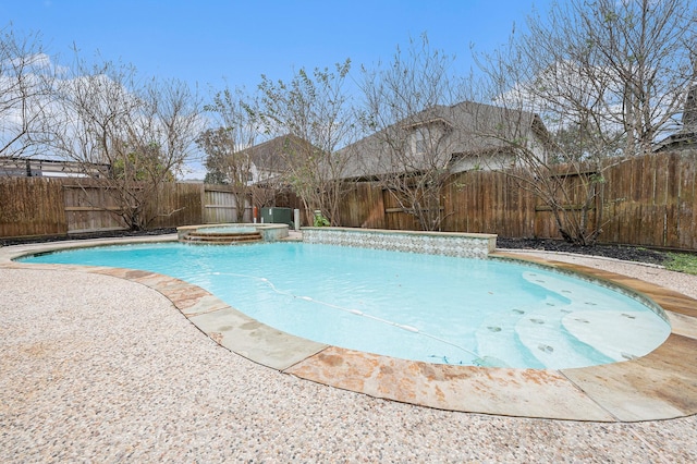 view of pool with a pool with connected hot tub and a fenced backyard