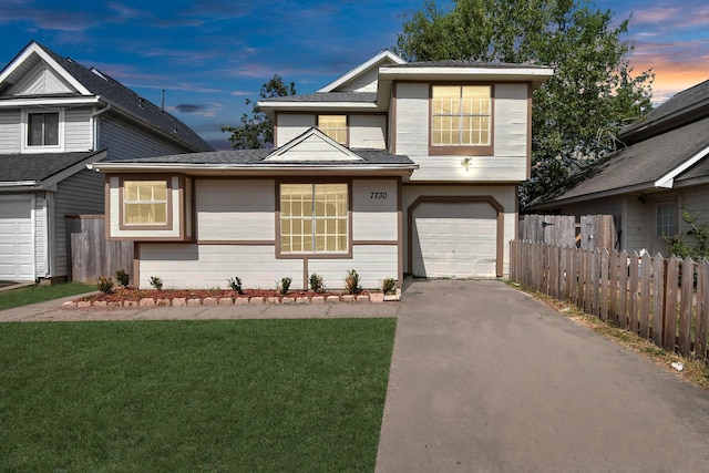 view of front facade with a yard and a garage