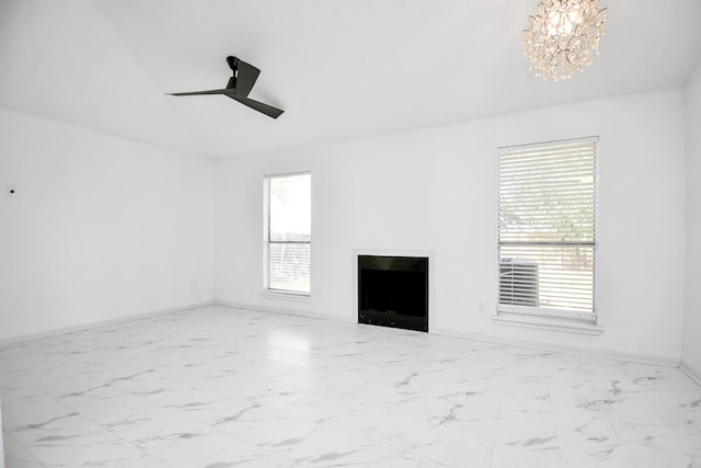 unfurnished living room with ceiling fan with notable chandelier