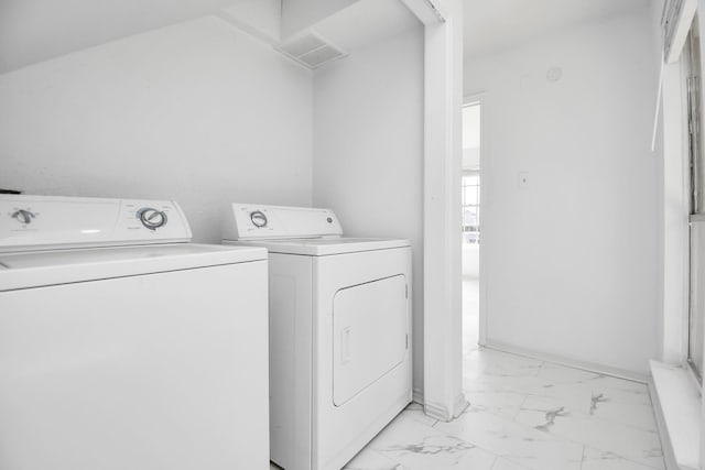 clothes washing area with washing machine and dryer