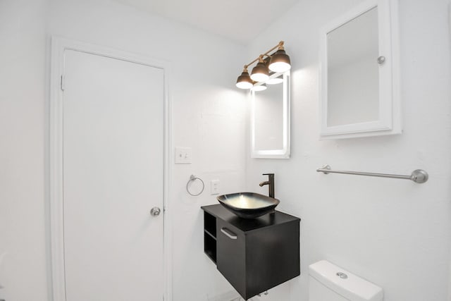 bathroom featuring toilet and vanity