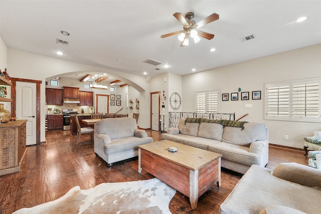 living room with ceiling fan and dark hardwood / wood-style flooring