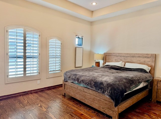 bedroom with dark hardwood / wood-style flooring