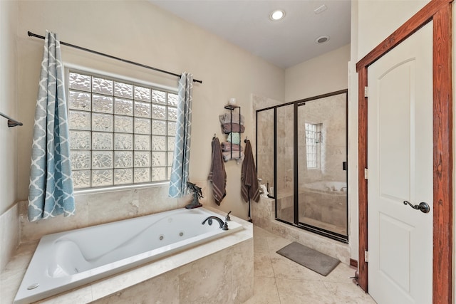 bathroom featuring shower with separate bathtub