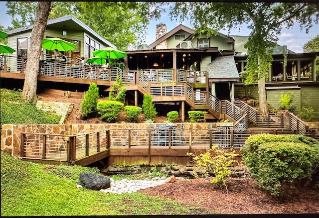 rear view of property with a wooden deck