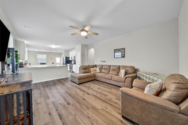 living room featuring ceiling fan and light wood-type flooring