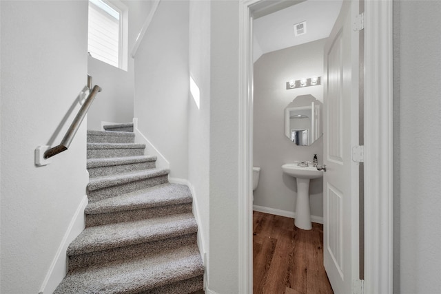 stairs with hardwood / wood-style floors