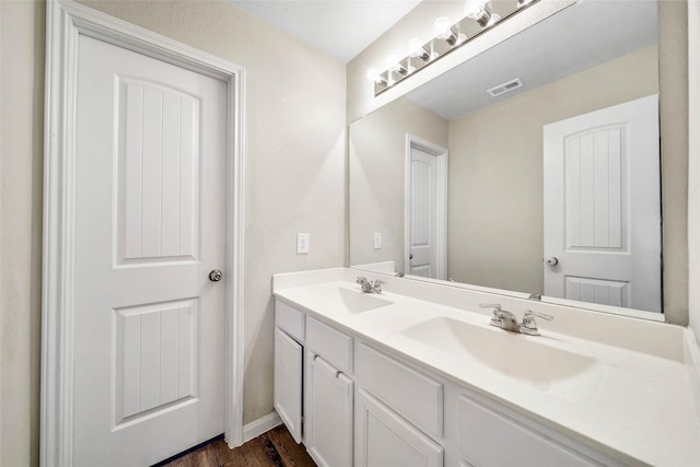 bathroom with vanity and wood-type flooring