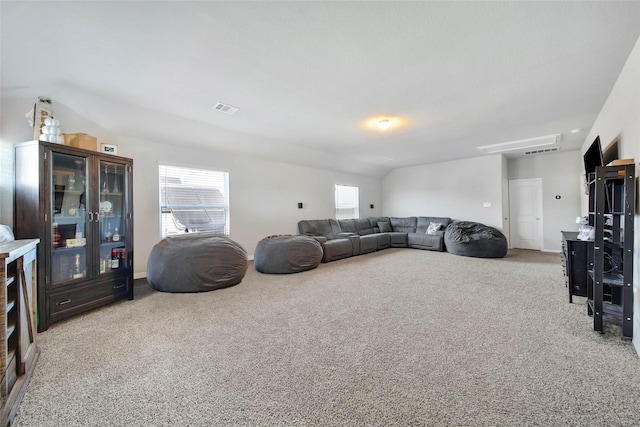 living room featuring carpet floors and vaulted ceiling