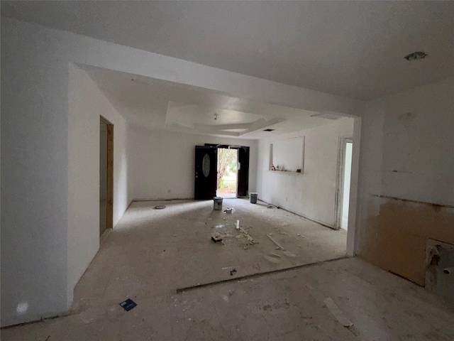 unfurnished room featuring a tray ceiling