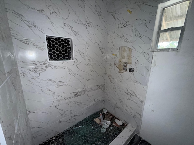 bathroom with tiled shower