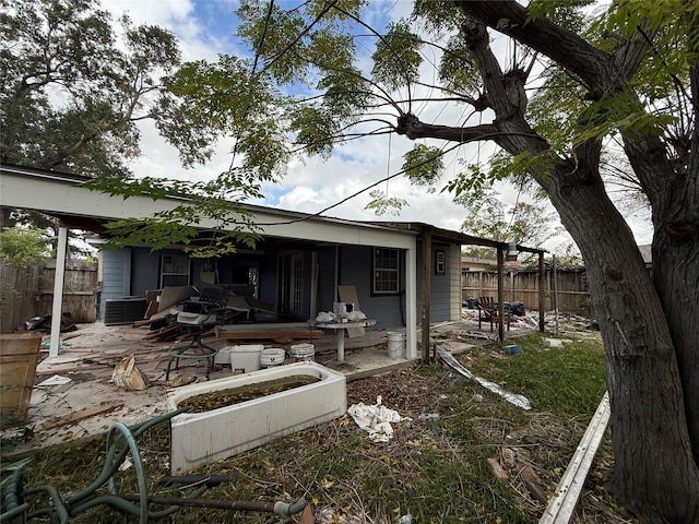 rear view of house featuring central AC unit and a patio area