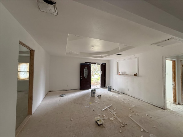 unfurnished room with a raised ceiling