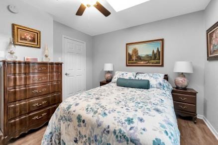 bedroom with ceiling fan and light hardwood / wood-style floors