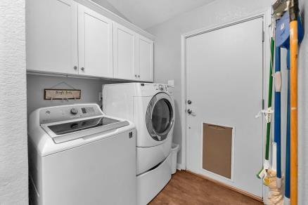 laundry area with washer and dryer and cabinets