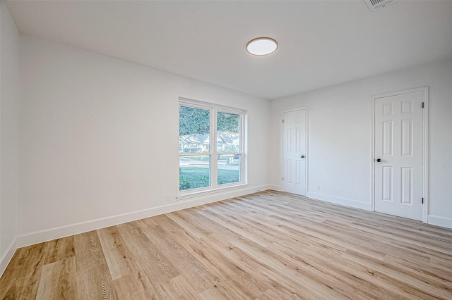 empty room with light hardwood / wood-style flooring