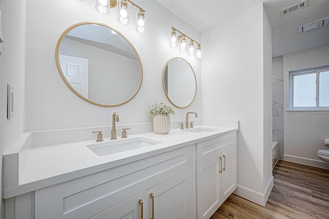 full bathroom with toilet, shower / bath combination, wood-type flooring, and vanity