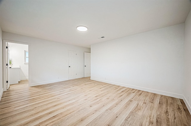 spare room with light wood-type flooring