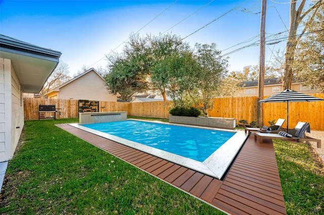 view of swimming pool with a yard and grilling area