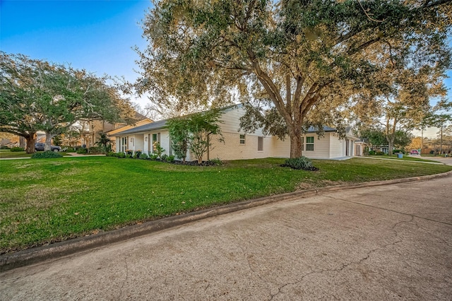 view of side of home featuring a yard and a garage