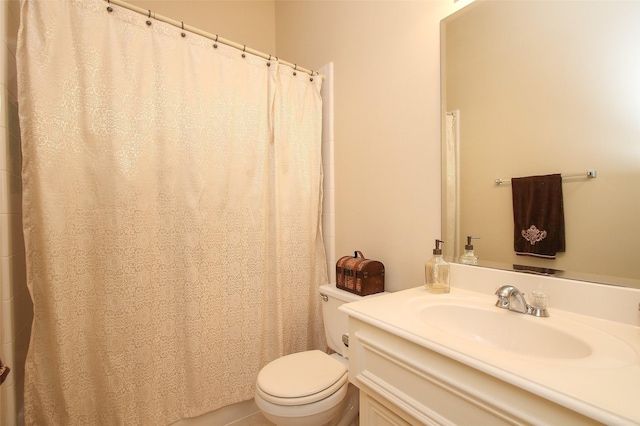 bathroom featuring vanity, toilet, and tile patterned flooring