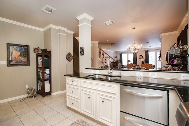 kitchen featuring sink, light tile patterned floors, white cabinetry, decorative columns, and stainless steel dishwasher