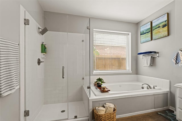 bathroom featuring separate shower and tub