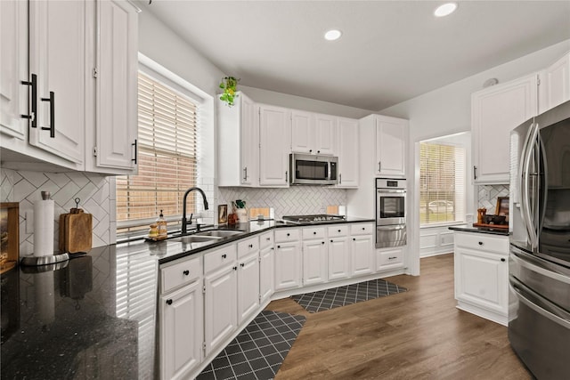 kitchen with white cabinets, appliances with stainless steel finishes, and sink