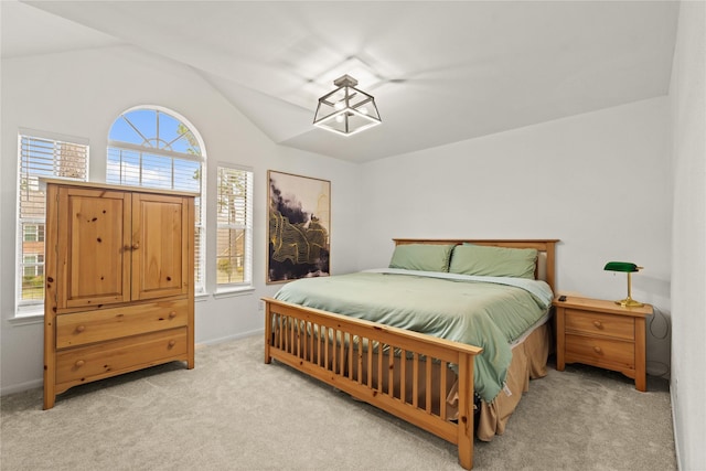 carpeted bedroom featuring vaulted ceiling