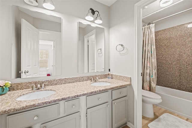 full bathroom featuring toilet, vanity, and shower / bathtub combination with curtain