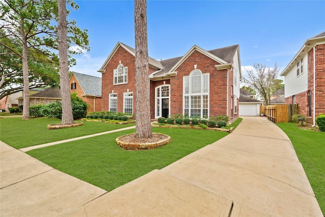 view of front property with a garage, an outdoor structure, and a front lawn