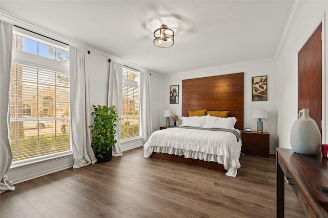 bedroom featuring ornamental molding and dark hardwood / wood-style floors