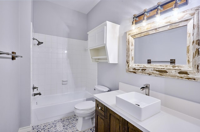 full bathroom featuring toilet, tiled shower / bath, and vanity